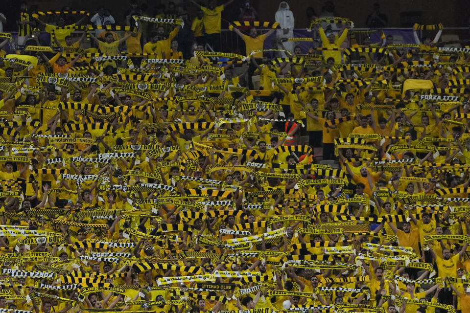 Al Ittihad supporters cheer at the stands prior the Soccer Club World Cup first round soccer match between Al Ittihad and Auckland City FC at King Abdullah Sports City stadium in Jeddah, Saudi Arabia, Tuesday, Dec. 12, 2023. (AP Photo/Manu Fernandez)