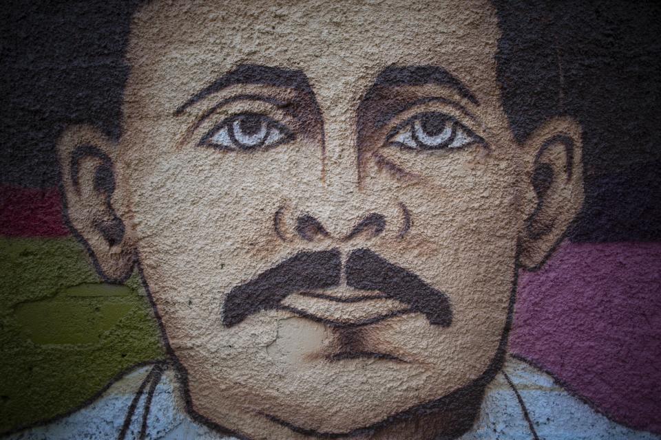 A mural of Venezuelan popular saint, Dr. Jose Gregorio Hernandez by Venezuelan artist Miguel Garcia, stands in Caracas, Venezuela, Monday, April 26, 2021. Known as the doctor of the poor, Hernandez is set to be beatified by the Catholic church, a step towards sainthood, on April 30th. (AP Photo/Ariana Cubillos)