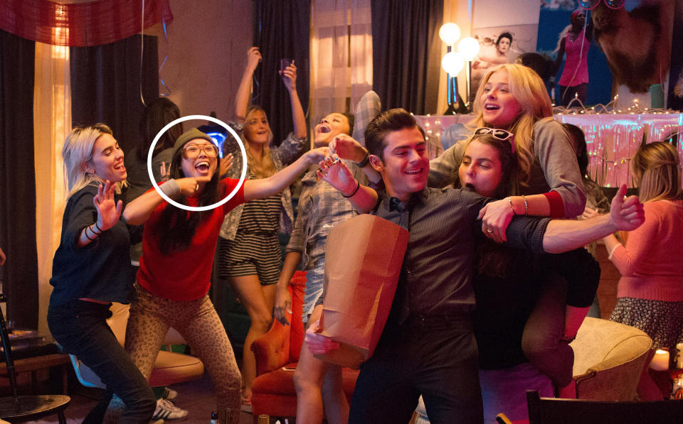 Group of people including Awkwafina, Zac Efron, Beanie Feldstein and Chloë  Grace Moretz having fun at a party, dancing and smiling