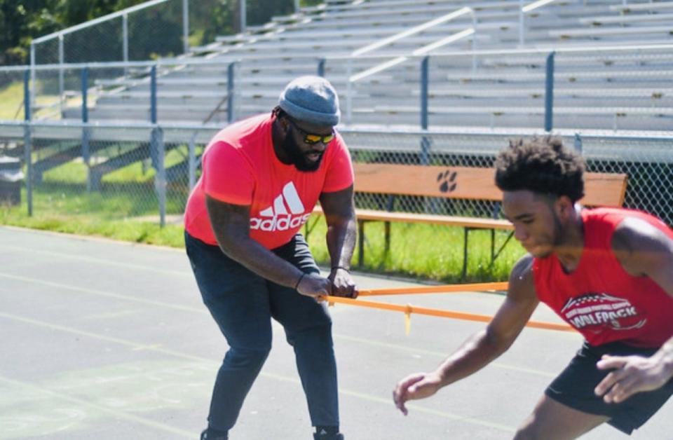 Greg Gilmore, left, a former NFL player, runs a nonprofit that helps athletes move to the collegiate or professional level.