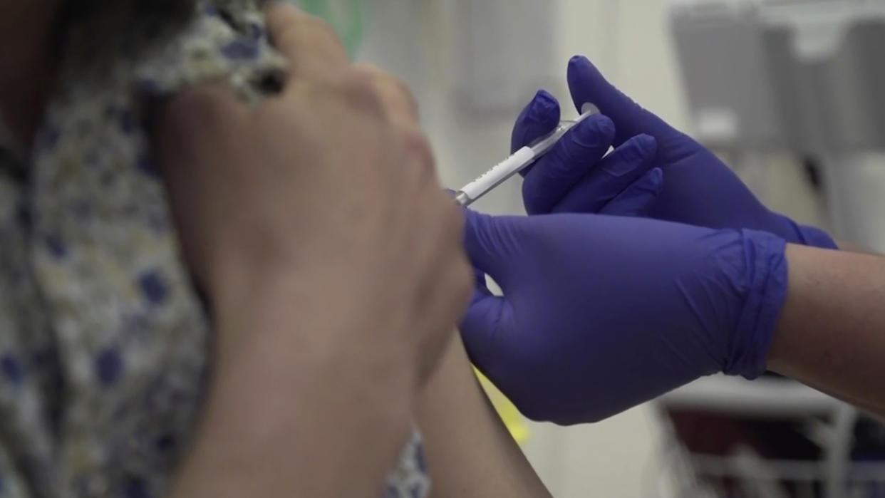 Screen grab taken from video issued by Britain's Oxford University, showing a person being injected as part of the first human trials in the UK to test a potential coronavirus vaccine, untaken by Oxford University, England, Thursday April 23, 2020.  The first vaccine trial for COVID-19 Coronavirus have begun Thursday. (Oxford University Pool via AP)