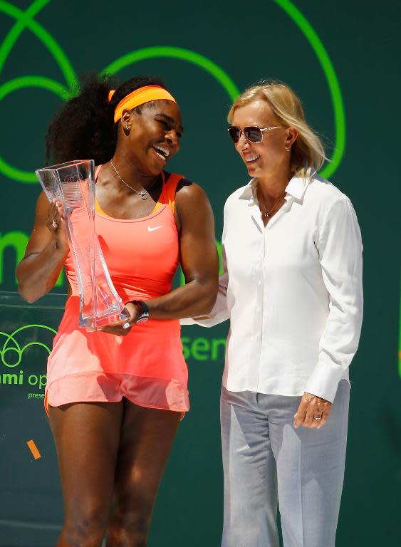 Serena Williams stands with Martina Navratilova after she defeated Carla Suarez Navarro of Spain in the women's finals of the Miami Open on April 4, 2015 in Key Biscayne, Florida