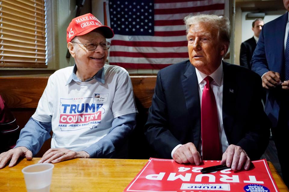 Former President Donald Trump, right, speaks with supporters at the Westside Conservative Breakfast, Thursday, June 1, 2023, in Des Moines, Iowa. (AP Photo/Charlie Neibergall)