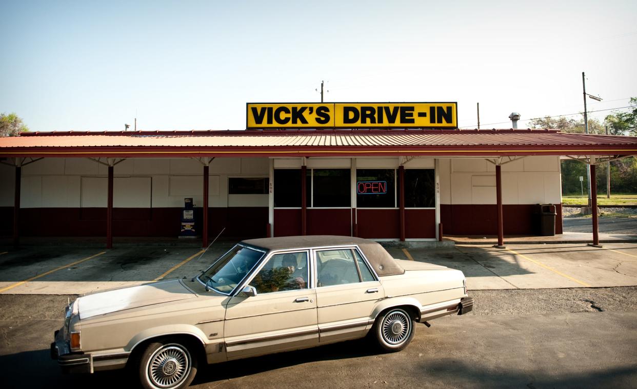 A car pulls out of the parking lot Friday morning at Vick's Drive In, April 2, 2010.  Vick's Drive In will have to close at its current location when the state is ready to build a new Rowan Street bridge.