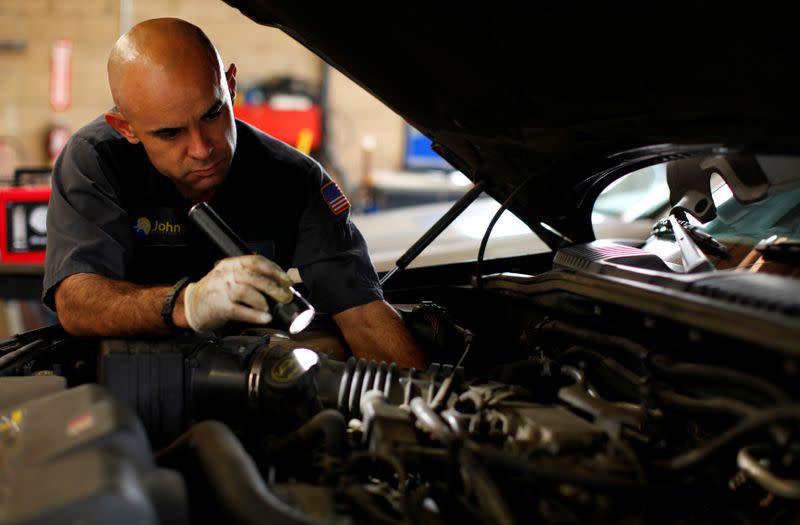 FILE PHOTO: Mechanics Tony Shelton works on a car at a garage in San Diego, California