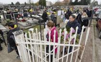 <p>People visit a cemetery in Lomna near Warsaw, Poland, Wednesday, Nov. 1, 2017. Candles and flowers cover tombstones in graveyards across Poland on All Saints’ Day. (Photo: Czarek Sokolowski/AP) </p>