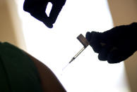 FILE - A droplet falls from a syringe after a health care worker was injected with the Pfizer-BioNTech COVID-19 vaccine at a hospital in Providence, R.I., Tuesday, Dec. 15, 2020. In 2023, many conspiracy theorists claimed a long-planned test of the emergency broadcast system would activate chemicals contained within COVID-19 vaccines. Those who got the shot would be killed, or perhaps turned into zombies. (AP Photo/David Goldman, File)