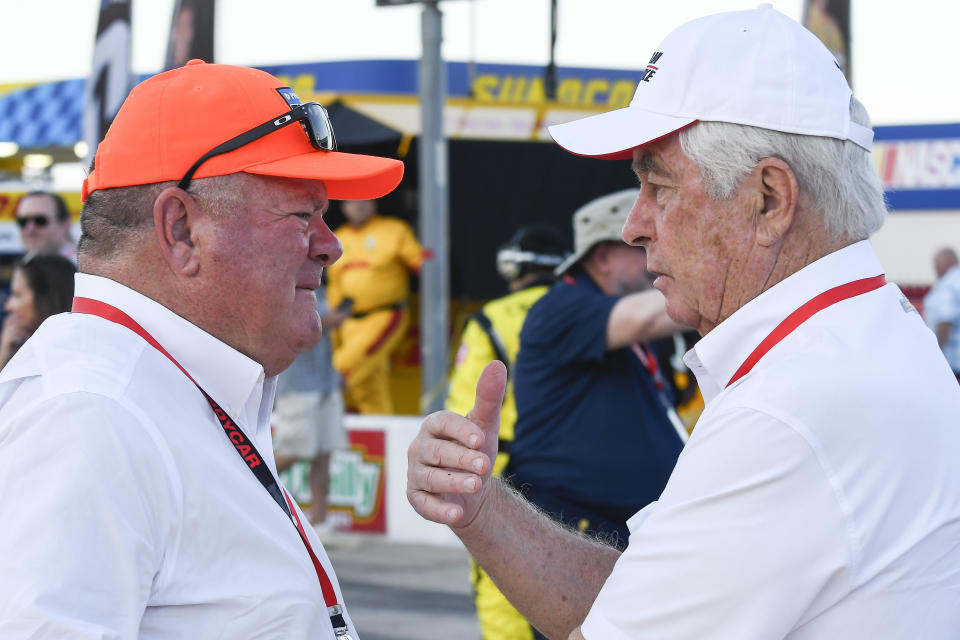 FILE - Team owners Chip Ganassi, left, and Roger Penske, right, greet each other on pit road before an IndyCar auto race at Texas Motor Speedway in Fort Worth, Texas, in this Saturday, June 8, 2019, file photo. The IndyCar series begins with the Grand Prix of Alabama at Barber Motorsports Park in Birmingham on April 18. (AP Photo/Randy Holt, File)