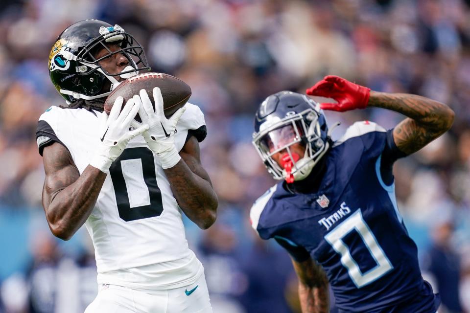 Jaguars wide receiving pulls in a pass from Trevor Lawrence against the Tennessee Titans on Sunday for a 59-yard TD pass in the first half.