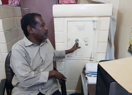 Lawyer Mohamed Mahmoud holds the lock of his safe box behind his desk in Khartoum, Sudan September 6, 2018. REUTERS/Eric Knecht