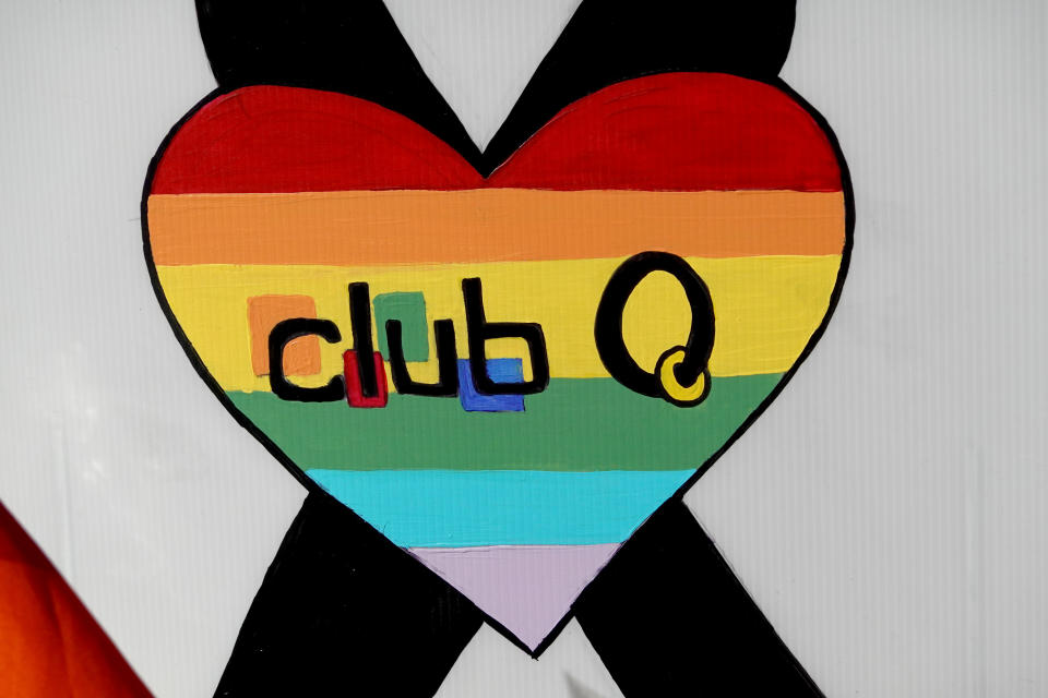 A sign with a rainbow-striped heart and the words: Club Q.