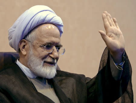 Iranian presidential candidate Mehdi Karroubi waves to journalists during a news conference in Tehran in this April 28, 2009 file photo. REUTERS/Raheb Homavandi/Files