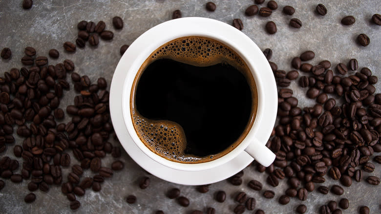 Coffee in cup with beans