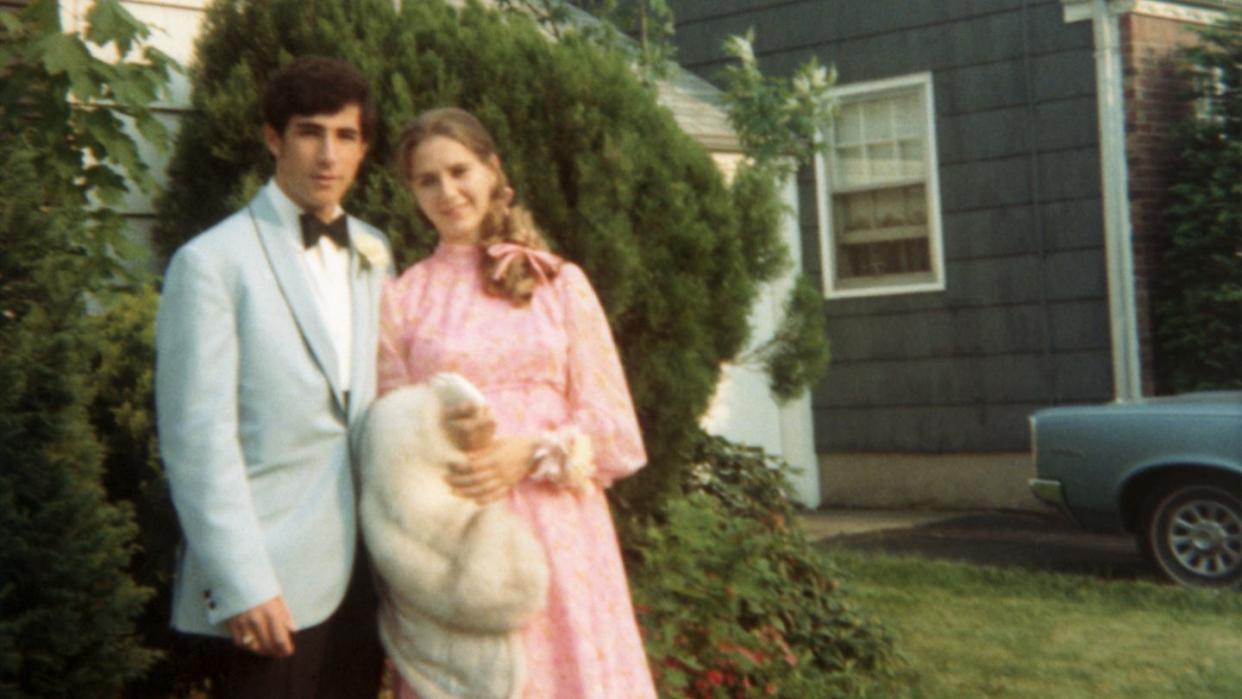 Teenage couple (16-18) wearing formal attire on lawn, portrait