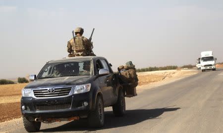 U.S. soldiers drive a military vehicle on the road connecting al-Rai town to Azaz city, northern Aleppo countryside, Syria, October 2016. REUTERS/Khalil Ashawi