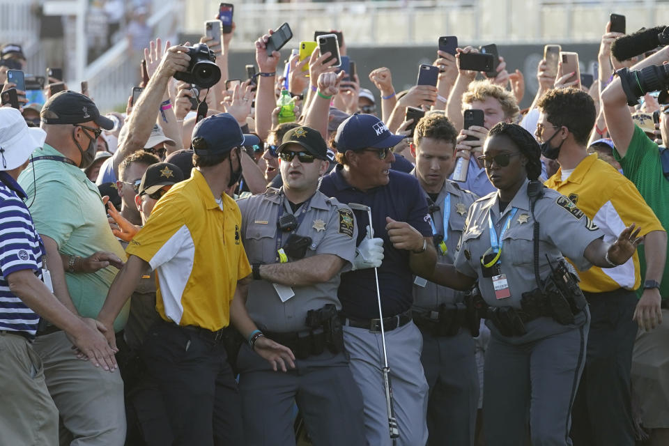 Phil Mickelson tries to get through the crowd during the final round at the PGA Championship golf tournament on the Ocean Course, Sunday, May 23, 2021, in Kiawah Island, S.C. (AP Photo/Matt York)
