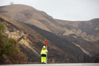 <p>Traffic is diverted on Foothill Road as workers place K-rail barricades along burn areas during a winter rain storm in Ventura, Calif., Jan. 9, 2018. (Photo: Monica Almeida/Reuters) </p>