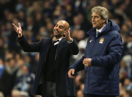 Bayern Munich's coach Pep Guardiola (L) reacts next to Manchester City's manager Manuel Pellegrini during their Champions League Group E soccer match in Manchester, November 25, 2014. REUTERS/Phil Noble