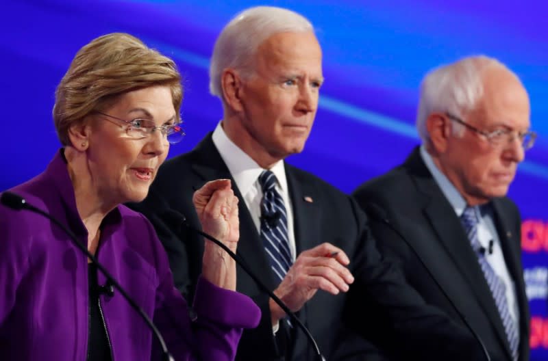 Democratic 2020 U.S. presidential candidates Senator Elizabeth Warren speaks with former Vice President Joe Biden and Senator Bernie Sanders listening at the seventh Democratic 2020 presidential debate at Drake University in Des Moines