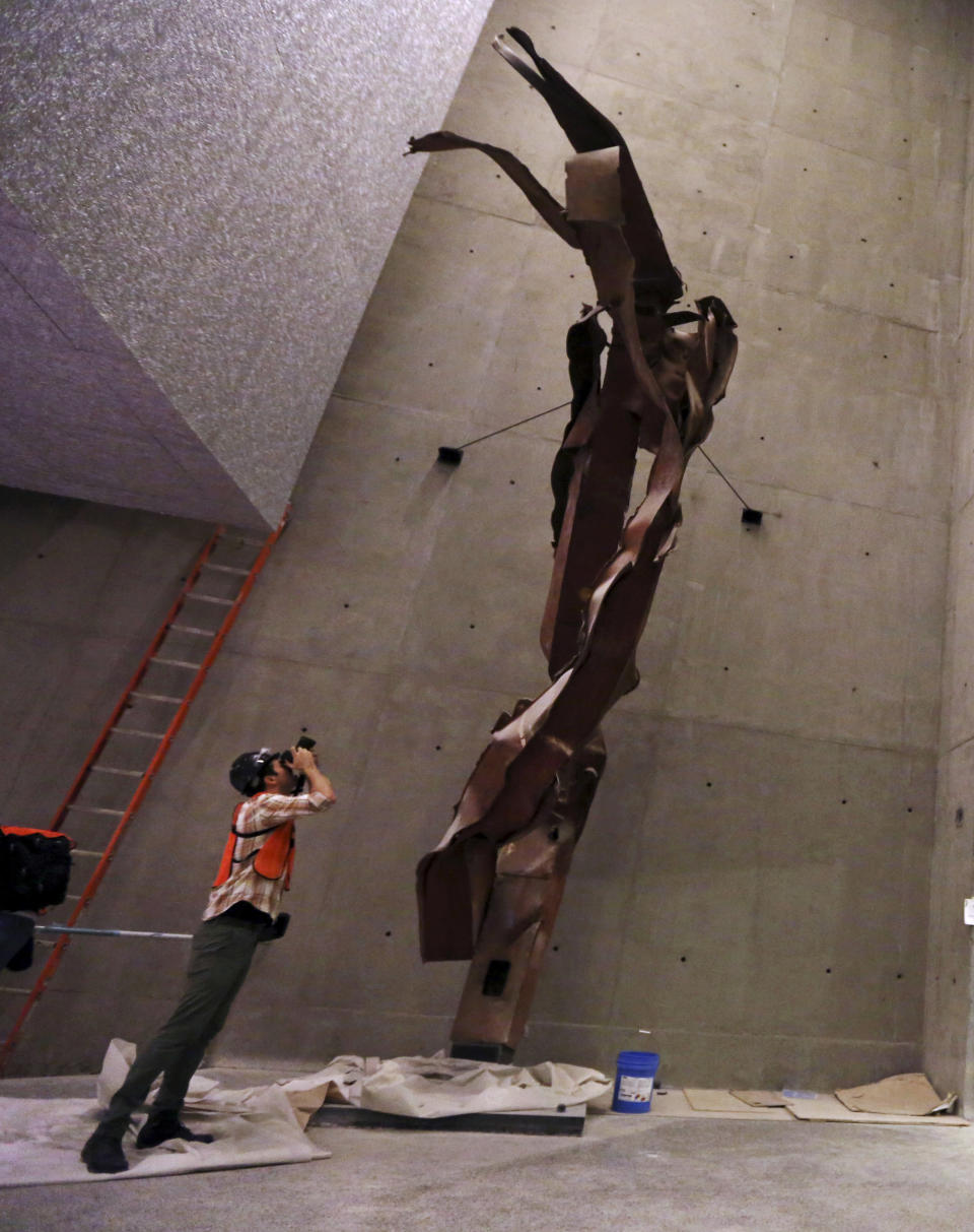 FILE - In this Sept. 6, 2013 file photo, a photographer take a picture of steel column from the North Tower of the World Trade Center during a media tour of the National September 11 Memorial and Museum, Friday, Sept. 6, 2013 in New York. The long-awaited museum dedicated to the victims of the Sept. 11 terror attacks will open to the public at the World Trade Center site on May 21, officials announced Monday, March 24, 2014. (AP Photo/Mary Altaffer, File)