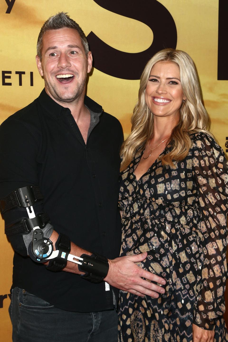 Ant Anstead holds Christina Haack's baby bump.