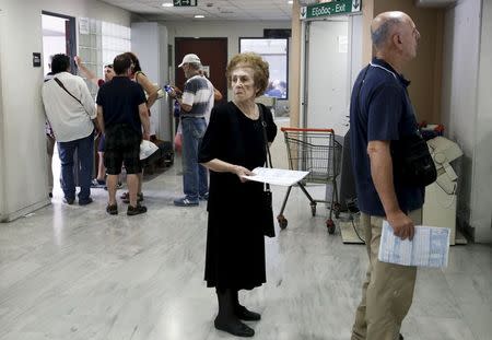 A woman holds her tax declaration form inside a tax office in Athens, Greece, June 25, 2015. REUTERS/Alkis Konstantinidis