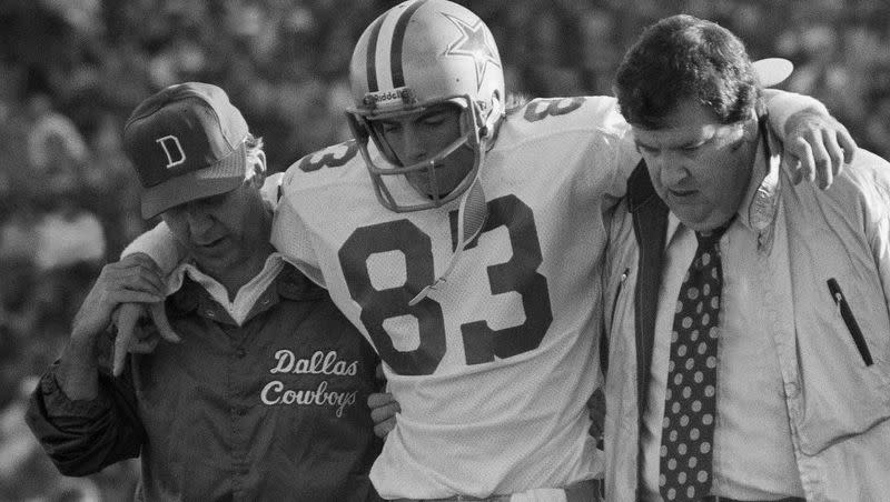 Dallas Cowboys wide receiver Golden Richards (83) being helped off the field after being injured in the NFC championship game against the Los Angeles Rams, in Los Angeles on Jan. 4, 1976.