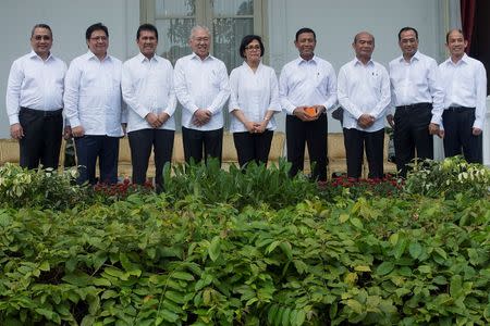 Indonesia's new ministers, (L-R) Transmigration Minister Eko Putro Sandjojo, Industry Minister Airlangga Hartarto, Administrative and Bureaucratic Reform Minister Asman Abnur, Trade Minister Enggartiasto Lukita, Finance Minister Sri Mulyani Indrawati, Coordinating Minister for Legal, Security and Politics Wiranto, Education Minister Muhadjir Effendy, Transportation Minister Budi Karya Sumadi, and Energy and Mining Minister Archandra Tahar, pose for photographers during the announcement of the new cabinet at Presidential Palace in Jakarta, Indonesia, July 27, 2016. Antara Foto/Widodo S Jusuf/via REUTERS