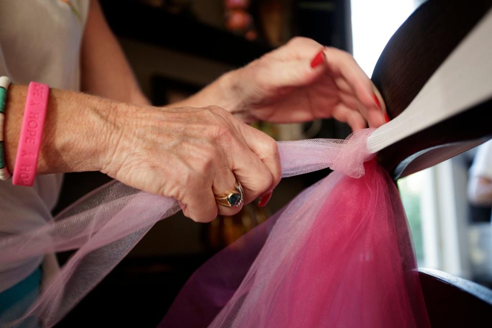 The Mixed Housewives of Del Webb, a group of women in the Del Webb neighborhood, craft pink tutus in Rancho Mirage, Calif., on Tuesday, October 4, 2022. The group fundraises for the Desert Cancer Foundation and plan to participate in the 16th Annual Paint El Paseo Pink breast cancer awareness walk. 