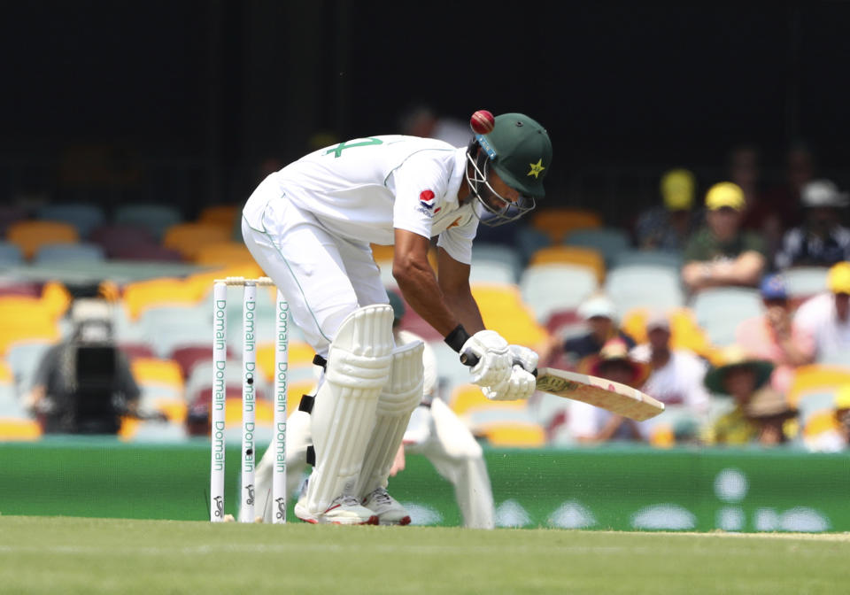 Pakistan's Shaan Masood gets hit by the ball during the cricket test match between Australia and Pakistan in Brisbane, Australia, Thursday, Nov. 21, 2019. (AP Photo/Tertius Pickard)