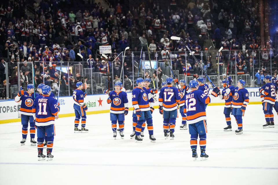 New York Islanders players celebrate after defeating the Colorado Avalanche in an NHL hockey game, Saturday, Oct. 29, 2022, in Elmont, N.Y. (AP Photo/Eduardo Munoz Alvarez)