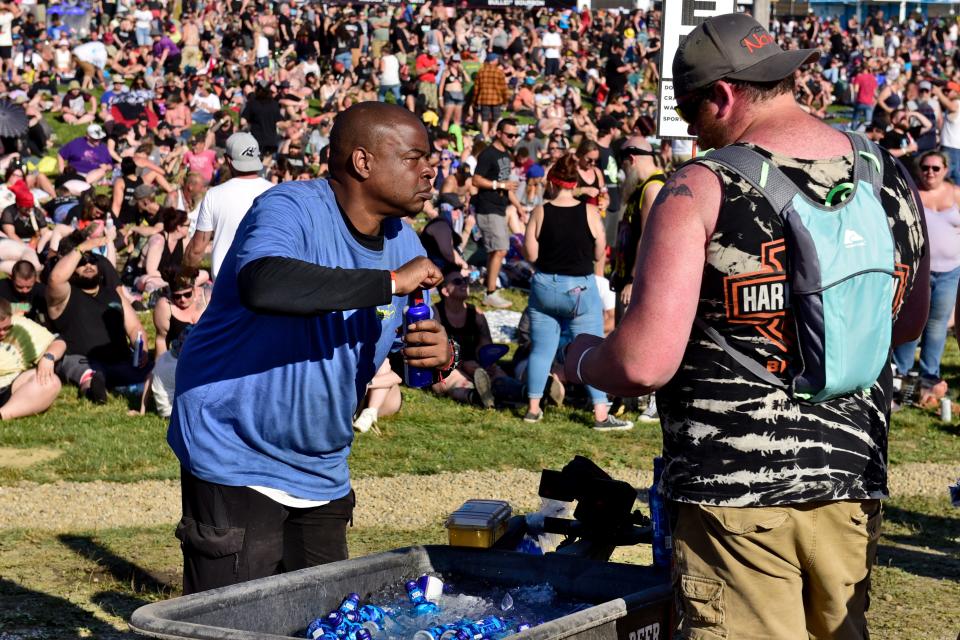 A beverage vendor makes a sale during the 2023 INKcarceration Music & Tattoo Festival at the Ohio State Reformatory in Mansfield.