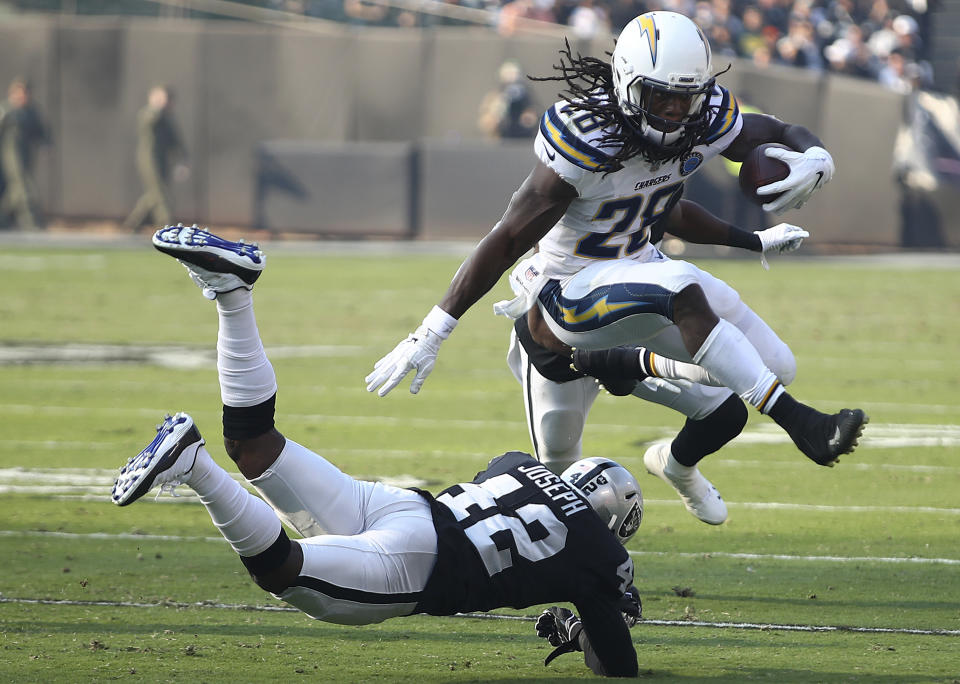 <p>Los Angeles Chargers running back Melvin Gordon III (28) jumps over Oakland Raiders safety Karl Joseph (42) during the first half of an NFL football game in Oakland, Calif., Sunday, Nov. 11, 2018. (AP Photo/Ben Margot) </p>