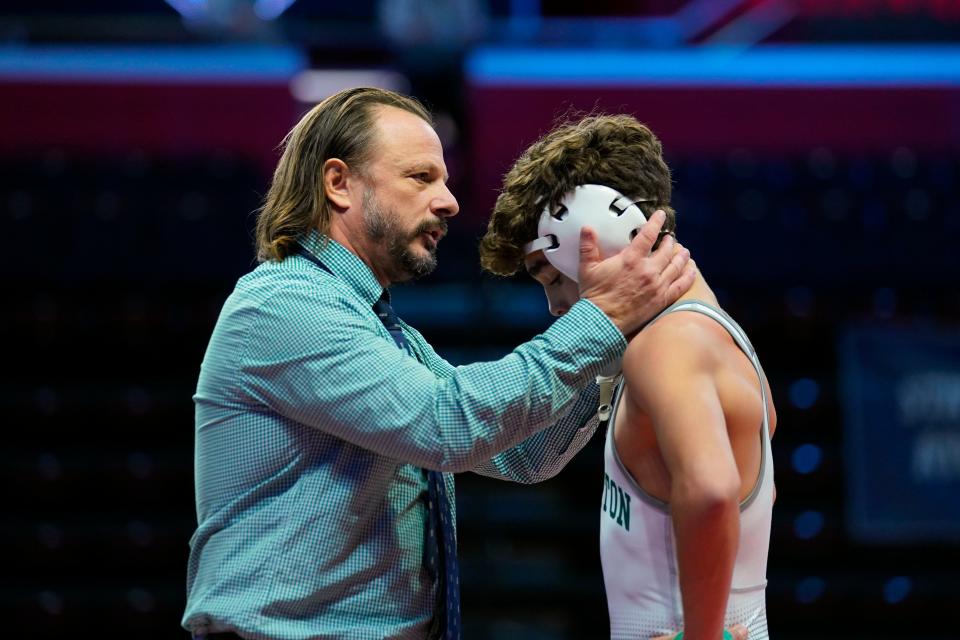 Delbarton head coach Brian Stoll congratulates Jayden James after his win over Mikey Bautista of Saint Joseph Regional (not pictured) in a 113-pound bout during the boys' wrestling team state finals at Jersey Mike's Arena in Piscataway on Sunday, Feb. 12, 2023.