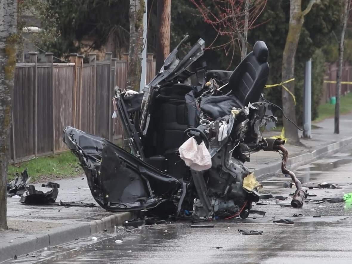 The wreckage of a Jaguar that crashed in Surrey, B.C., early Thursday. The driver was taken to hospital with life-threatening injuries. (Shane MacKichan - image credit)