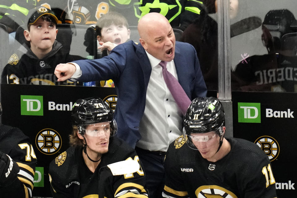 Boston Bruins head coach Jim Montgomery calls to his players during the second period of an NHL hockey game against the Dallas Stars, Monday, Feb. 19, 2024, in Boston. (AP Photo/Charles Krupa)