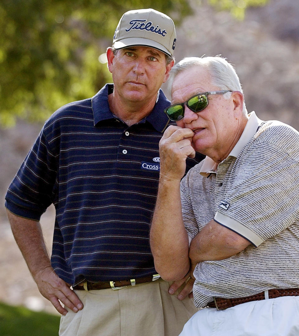 FILE - Jay Haas, left, talks to 1968 Masters champion Bob Goalby on the fifth hole at Indian Wells Country Club during the third round of the Bob Hope Chrysler Classic golf tournament Jan. 31, 2003, in Indian Wells, Calif. Goalby is also Haas' uncle. Goalby has died. His death Wednesday, Jan. 19, 2022, in his hometown of Belleville, Ill., was confirmed by the PGA Tour and Bill Haas, his great nephew. Goalby was 92. (AP Photo/Mark J. Terrill, File)