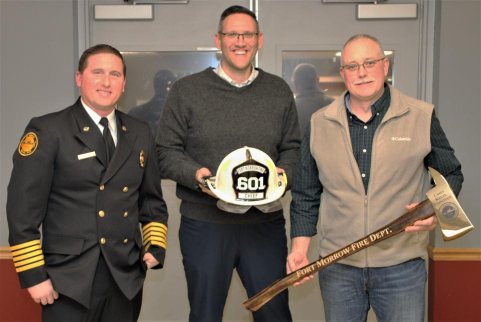 Retired Fort Morrow Fire District Chief Kevin Edington, right, was honored for his service to the department during the annual dinner held Saturday, Jan. 21, 2023, at the fire hall in Waldo. He was presented with a commemorative axe and his helmet as tokens of appreciation. Also pictured are new Chief Tyler Lowe, left, and fire district board member Mike Augenstein, who represents Waldo Township.