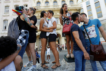 Cuban LGBT activists kiss each other while participating in an annual demonstration against homophobia and transphobia in Havana, Cuba May 11, 2019. REUTERS/Stringer