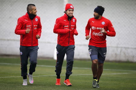 Chile's (L-R) Arturo Vidal, Jorge Valdivia and Jean Beausejour participate in a team training session in Santiago, Chile, July 2, 2015. Chile will face Argentina for their Copa America final on July 4. REUTERS/Ivan Alvarado