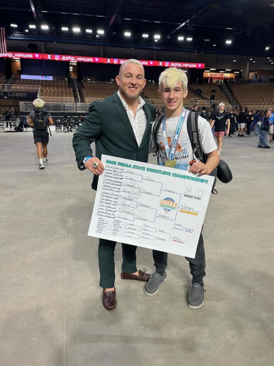 Palmetto Ridge head coach Blaine Ison and senior Tyler Washburn poses after Washburn won his third state title on March 4, 2023.