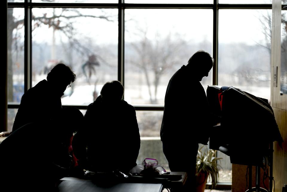 FILE - Residents cast their votes at the Warner Park Community Recreation Center on the first day of early voting, March 21, 2023, in Madison, Wis. Wisconsin voters are being asked to make it unconstitutional to accept private grant money to help administer elections, a Republican-backed effort in the ongoing battle over how to run elections in the presidential battleground state. That proposed constitutional amendment, along with a related one saying that only election officials designated by law may administer elections, are both on the state's April 2, 2024 ballot. (AP Photo/Morry Gash, file)