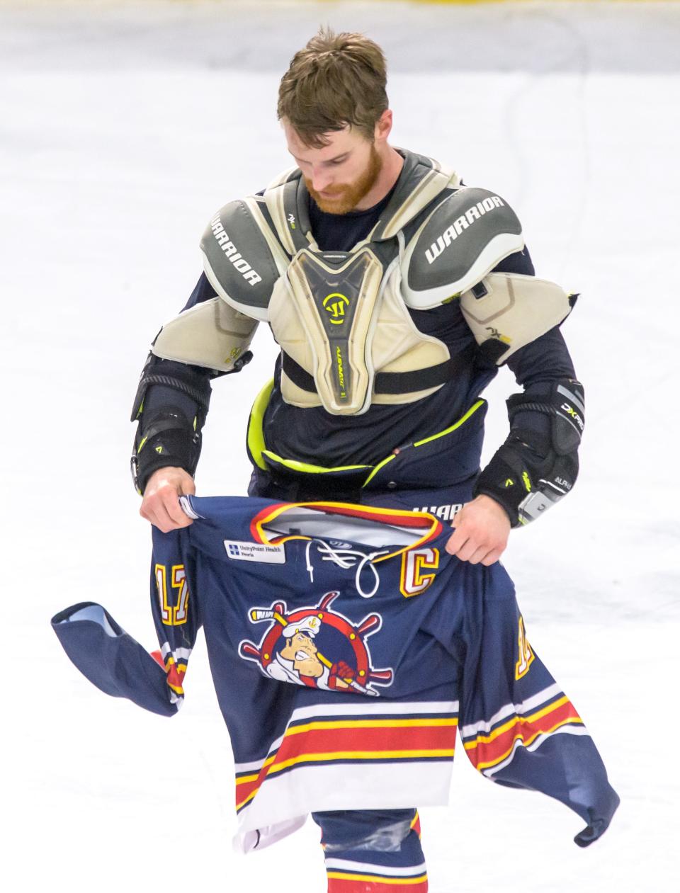 Retiring Peoria captain Alec Hagaman removes his jersey to lay it on center-ice after Game 3 of the SPHL semifinals Sunday, April 23, 2023 at Carver Arena. The Rivermen fell 5-3 to the Roanoke Rail Yard Dawgs.