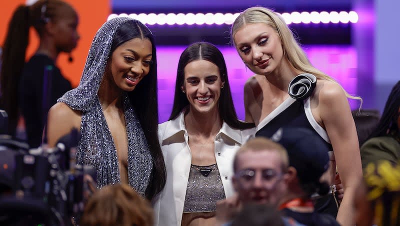 From left, LSU's Angel Reese, Iowa's Caitlyn Clark, and Stanford's Cameron Brink, pose for a photo before the start of the WNBA basketball draft, Monday, April 15, 2024, in New York.