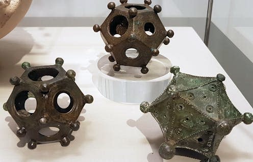 <span class="caption">Two dodecahedra and an icosahedron on display in the Rheinisches Landesmuseum Bonn, Germany.</span> <span class="attribution"><a class="link " href="https://commons.wikimedia.org/wiki/File:2018_Rheinisches_Landesmuseum_Bonn,_Dodekaeder_%26_Ikosaeder.jpg" rel="nofollow noopener" target="_blank" data-ylk="slk:Kleon3/Wiki Commons;elm:context_link;itc:0;sec:content-canvas">Kleon3/Wiki Commons</a>, <a class="link " href="http://creativecommons.org/licenses/by-sa/4.0/" rel="nofollow noopener" target="_blank" data-ylk="slk:CC BY-SA;elm:context_link;itc:0;sec:content-canvas">CC BY-SA</a></span>