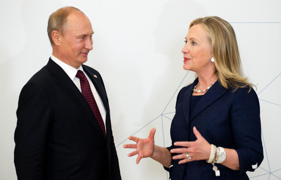 U.S. Secretary of State Hillary Rodham Clinton, right, talks with Russian President Vladimir Putin during the arrival ceremony for the Asia-Pacific Economic Cooperation (APEC) Summit in Vladivostok, Russia, Saturday, Sept. 8, 2012. (AP Photo/Jim Watson, Pool)