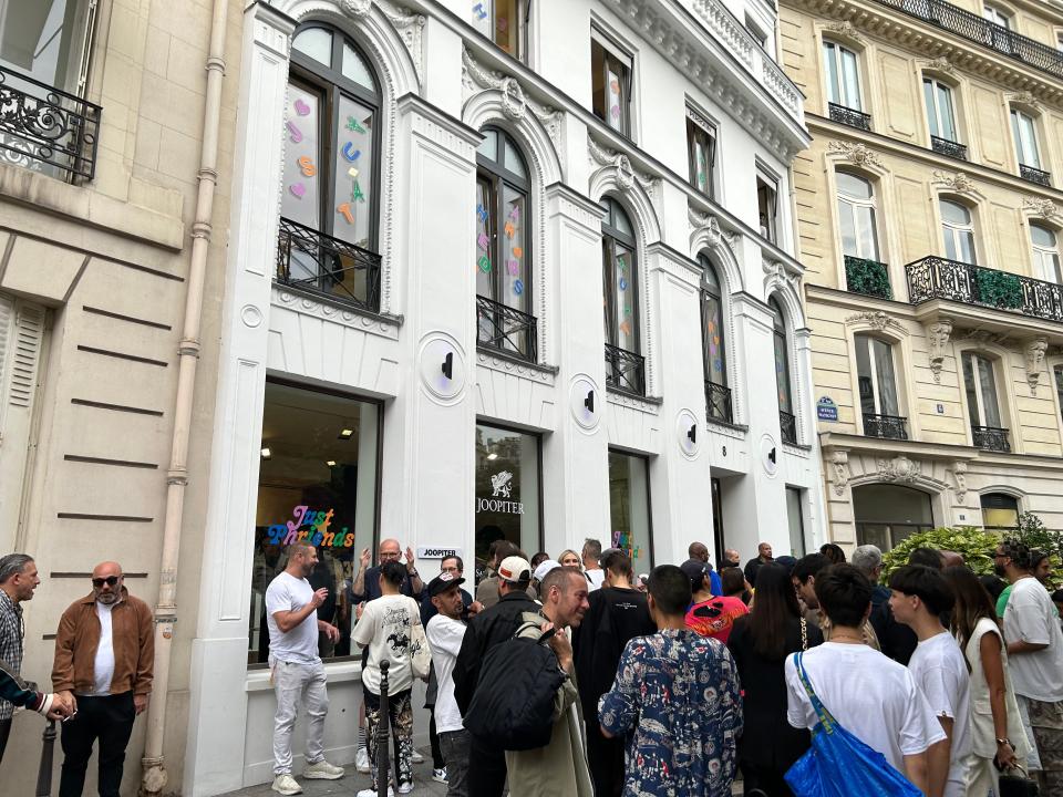 people crowding outside of the joopiter building in france for a paris fashion week event