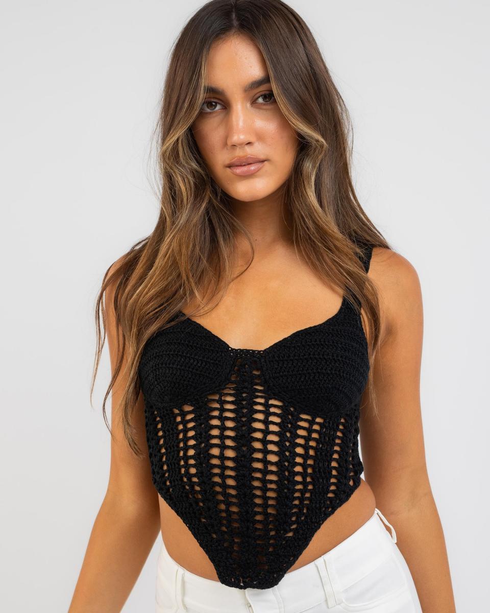 model wearing crochet black top with white jeans