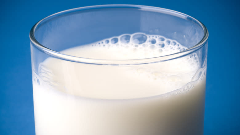 glass of milk with blue background
