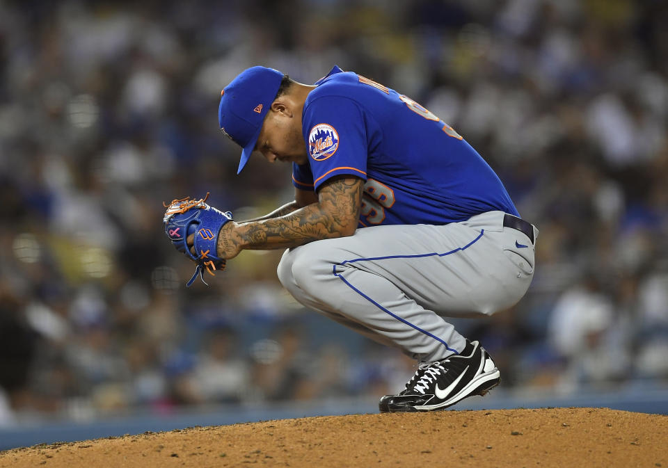 LOS ANGELES, CA - AUGUST 19: Starting pitcher Taijuan Walker #99 of the New York Mets reacts on the mound during a break in the action after giving up a run to the Los Angeles Dodgers during the fifth inning at Dodger Stadium on August 19, 2021 in Los Angeles, California. (Photo by Kevork Djansezian/Getty Images)